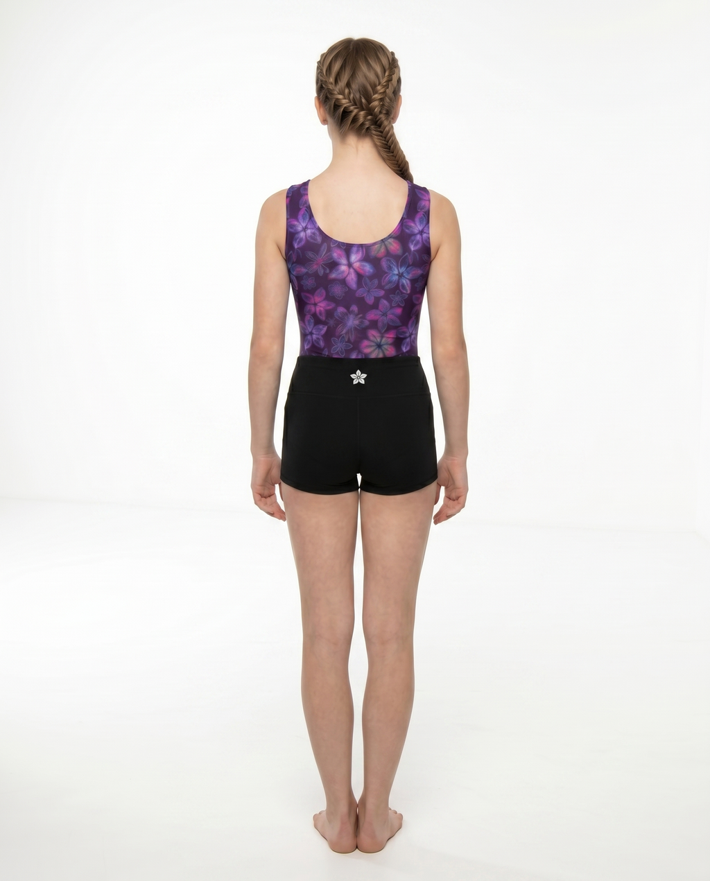 Girls back view classic gymnastics bodysuit (leotard) in plumeria print with back gymnastics shorts