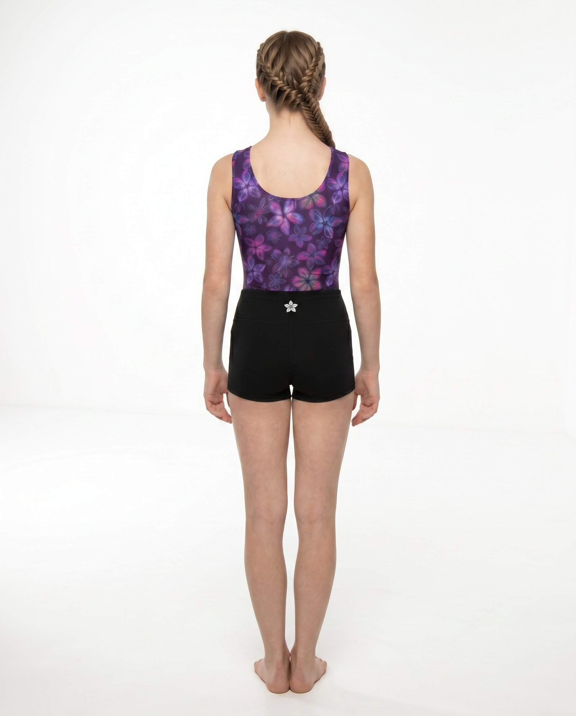 Girls back view classic gymnastics bodysuit (leotard) in plumeria print with back gymnastics shorts